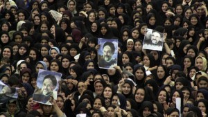In this September 2002, file photo, Iranian women hold pictures of President Mohammad Khatami during a public welcoming ceremony at the Azadi stadium in the city of Rasht northwest of capital Tehran, Iran. A similar rally in support of President Ahmadinejad and Rahim Mashaei, who Ahmadinejad has selected to succeed him as his party's candidate for the presidency, is expected on Thursday. (AP Photo/Vahid Salemi, File)