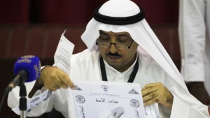 A judge counts votes during the early hours of the night after elections closed at the Khaldiya polling station in District 3, Kuwait City, on July 27, 2013. (REUTERS/Hamad I Mohammed)