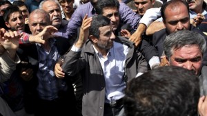 Escorted by his bodyguards, Iranian president Mahmoud Ahmadinejad, center, waves to his well wishers as he attends an annual nation-wide pro-Palestinian rally marking Al-Quds (Jerusalem) Day in Tehran, Iran, on Friday, August 2, 2013. (AP Photo/Ebrahim Noroozi)