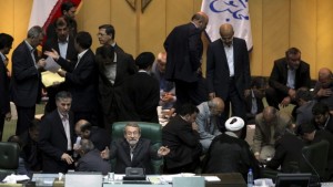 Iranian parliament speaker Ali Larijani, center, gestures as lawmakers count the votes of their colleagues for President Hassan Rouhani's proposed Cabinet at the parliament in Tehran, Iran, on Thursday, August 15, 2013. (AP Photo/Ebrahim Noroozi)