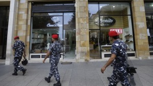 Lebanese policemen patrol in front the Turkish airlines office in downtown Beirut, Lebanon, on Tuesday, August 13, 2013. (AP Photo/Hussein Malla)