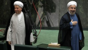 Iranian president Hassan Rouhani (R) arrives in parliament in Tehran, accompanied by the Islamic Republic's former president, Akbar Hashemi Rafsanjani (L), in this August 4, 2013, file photo. (AFP PHOTO/ATTA KENARE)