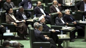 Iranian president Hasan Rouhani, center with white turban, attends a session of the parliament to debate on his proposed Cabinet in Tehran, Iran, on Tuesday, August 13, 2013. (AP Photo/Ebrahim Noroozi)
