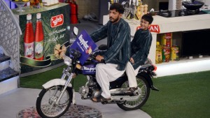 In this photograph taken on July 31, 2013, a Pakistani Muslim man rides on a motorbike which he won on an Islamic quiz show Aman Ramadan in Karachi. In the battle for TV ratings, Pakistan's top channels are making money out of Ramadan by broadcasting round-the-clock chat shows mixing prizes, charity and prayer. (AFP PHOTO/ASIF HASSAN)