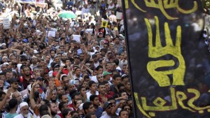 A flag of the "Rabaa" gesture, in reference to the police clearing of Rabaa Al-Adawiya protest camp on August 14, is pictured during a protest by supporters of Muslim Brotherhood and ousted Egyptian president Mohamed Mursi in Cairo on August 23, 2013. (REUTERS/Muhammad Hamed)