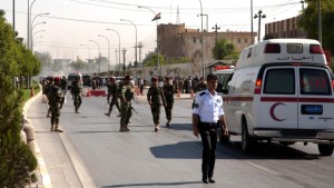Iraqi Kurdish security forces and medical services are seen at the site of an explosion in Arbil, outside the headquarters of the Kurdish aayesh security services in the capital of Iraqs autonomous Kurdistan region, on September 29, 2013. (AFP PHOTO / SAFIN HAMED AFP/AFP/SAFIN)