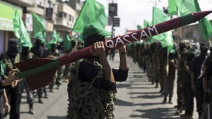 A Islamic Hamas movement militant carries a replica of a Gaza Strip made rocket as he takes part in a march in Gaza's Nusseirat refugee camp on September 27, 2013 in commemoration of the September 28, 2000 outbreak of the devastating second intifada. (AFP PHOTO / MAHMUD HAMS)