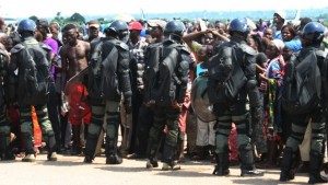 People fleeing ongoing violence are surrounded by a police security cordon as they seek refuge at the airport in Bangui, Central African Republic, on August 28, 2013.(AP Photo)