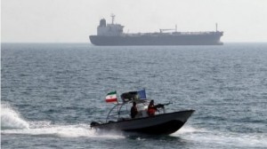 Iranian Revolutionary Guards drive a speedboat in front of an oil tanker at the port of Bandar Abbas on July 2, 2012. (Atta Kenare/AFP/File)
