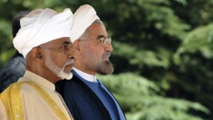 In this photo released by the official website of the Iranian Presidency office, President Hasan Rouhani, right, and Omani Sultan Qaboos listen to their countries' national anthems in an official arrival ceremony for Sultan Qaboos, in Tehran, Iran, on Sunday, August 25, 2013. (AP Photo/Iranian Presidency Office, Hojjat Sepahvand)