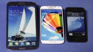 The Samsung Galaxy Mega, left, Samsung Galaxy S4, center, and Apple iPhone 5. (AP Photo/Richard Drew)