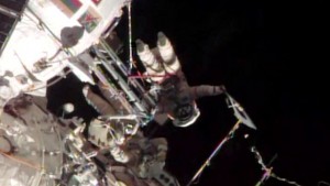 This screen image taken from NASA shows the Sochi Olympic torch being held during a spacewalk on Saturday, November 9, 2013. (AP Photo/NASA)