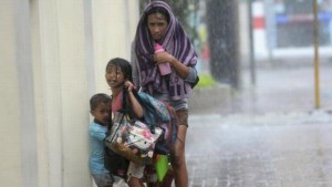 A mother takes refuge with her children as Typhoon Haiyan hits Cebu city (Reuters).