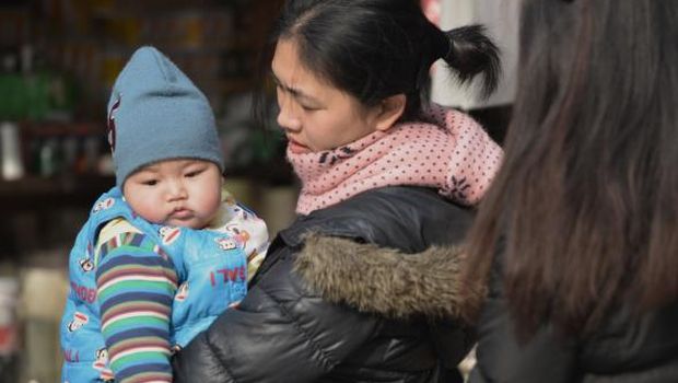 China formalizes easing of one-child policy