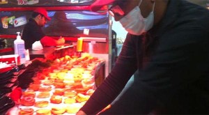 A worker prepares hamburgers in a Riyadh, Saudi Arabia burger joint. (Asharq Al-Awsat)