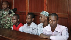 Left to right, four Somali nationals Hussein Hassan Mustafah, Adan Dheq, Liban Abdullah Omar, and Mohamed Ahmed Abdi, who are charged with offenses related to September's terrorist attack on Westgate Mall that killed at least 67 people, appear in court in Nairobi, Kenya Wednesday, Jan. 15, 2014. The trial of the four suspects arrested in conjunction with the mall attack and facing charges including harboring a fugitive and illegally registering as a Kenyan, opened in a Nairobi court on Wednesday, with two prosecution witnesses describing how the mall came under attack by four gunmen. (AP Photo/Khalil Senosi)