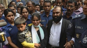 Two owners of Tazreen Fashions, Delwar Hossain, center left, and his wife, Mahmuda Akter, right, are escorted by security personnel to a court in Dhaka, Bangladesh, on Sunday, February 9, 2014. (AP Photo)