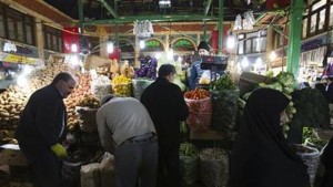 Customers shop at a vegetable store in Tehran, Iran on January 6, 2012. (Reuters/Raheb Homavandi)