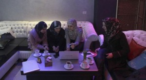 Abeer Abu Ghaith, 29, third from left, the first female high-tech entrepreneur in the West Bank, talks to other Palestinian women in the village of Dura. (AP/Nasser Shiyoukhi)