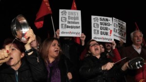 People shout slogans as they hold placards that read "stop censorship" during a rally against a proposed internet restriction bill, in Ankara, Turkey, on Saturday, January 18, 2014. (AP Photo/Burhan Ozbilici)