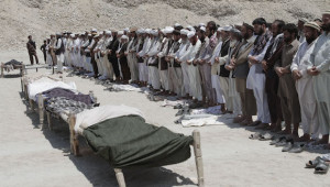 In this file photo taken Monday, June 3, 2013, Afghan men offer funeral prayers in front of the bodies of seven civilians killed by a roadside bomb in the Alingar district of Laghman province, east of Kabul, Afghanistan. The number of children killed and wounded in Afghanistan’s war jumped by 34 percent in 2013 as the Taliban intensified armed attacks across the country and continued to lay thousands of roadside bombs, according to a U.N. report Saturday, Feb. 8, 2014. (AP Photo/Rahmat Gul, File)