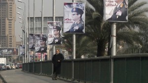 A man stands on a bridge where huge posters of Egypt's Army chief Field Marshal Abdel Fattah al-Sisi are hanged in central Cairo February 3, 2014. Egypt is pushing ahead with an army-backed plan for political transition, with presidential and parliamentary elections due to take place within months. Sisi is widely expected to announce his presidential bid and win easily. REUTERS/Asmaa Waguih (EGYPT - Tags: POLITICS)