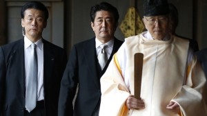 Japan's Prime Minister Shinzo Abe (C) is led by a Shinto priest as he visits Yasukuni shrine in Tokyo in this December 26, 2013, file photo. (REUTERS/Toru Hanai/Files)
