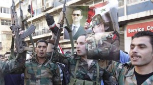 Soldiers from forces loyal to Syria's President Bashar al-Assad attend a rally supporting him and the army in Damascus February 19, 2014. REUTERS/Khaled al-Hariri (SYRIA - Tags: POLITICS CONFLICT CIVIL UNREST)