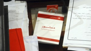 A copy of the new Tunisian Constitution lays on a parliament member's desk at the Constituent Assembly, in Tunis, Monday, Jan.27, 2014. The document is groundbreaking as one of the most progressive constitutions in the Arab world — and for the fact that it got written at all. It passed late Sunday by 200 votes out of 216 in the Muslim Mediterranean country that inspired uprisings across the region after overthrowing a dictator in 2011. (AP Photo/Hassene Dridi)