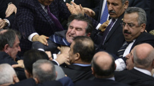 Turkish legislators from Prime Minister Recep Tayyip Erdogan's ruling party and the main opposition Republican People's Party brawl during a tense all-night debate over a controversial law on changes to a council that appoints and overseas judges and prosecutors, in Ankara, early Saturday, Feb. 15, 2014. One legislator suffered a broken finger while another suffered a nose-bleed. Opposition parties say the bill would give the government wider controls over the council.(AP Photo)