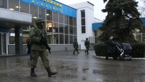 Armed men patrol at the airport in Simferopol, Crimea February 28, 2014. A group of armed men in military uniforms have seized the main regional airport in Simferopol, Crimea, Interfax news agency said early on Friday. REUTERS/David Mdzinarishvili (UKRAINE - Tags: POLITICS CIVIL UNREST TRANSPORT)