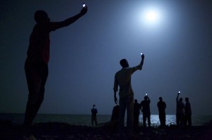 John Stanmeyer won the World Press Photo of the Year 2013 contest with this picture of African migrants on the shore of Djibouti city at night, taken on February 26, 2013. (REUTERS/John Stanmeyer/World Press Photo Handout via Reuters)