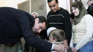 A handout picture released by the official Syrian Arab News Agency (SANA) shows Syria's President Bashar Al-Assad, left, visiting the Dweir shelter for the displaced people in the industrial city of Adra, northeast of the capital Damascus, on March 12, 2014. (AFP Photo/HO/SANA)