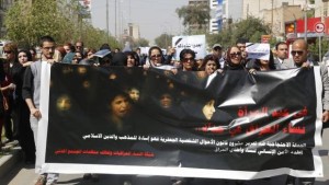 Iraqi protesters hold a banner during a demonstration against the draft of the Ja’afari Personal Status Law during International Women's Day in Baghdad on March 8, 2014. (Reuters/Thaier Al-Sudani)