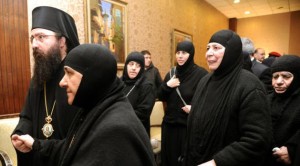 In this photo released by the Syrian official news agency SANA, a group of nuns who were freed after being held by rebels, greet church officials at the Syrian border town of Judaydat Yabus, early Monday, on March 10, 2014. (AP Photo/SANA)