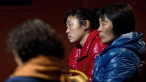 Chinese relatives of passengers aboard a missing Malaysia Airlines plane wait inside a hotel room in Beijing on Monday, March 10, 2014. (AP Photo/Andy Wong)