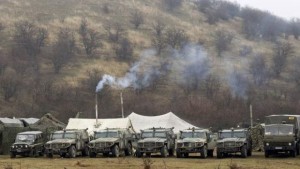 Military vehicles, believed to be property of the Russian army, are seen near the territory of a Ukrainian military unit in the village of Perevalnoye, outside Simferopol, March 7, 2014. (Reuters/Vasily Fedosenko)