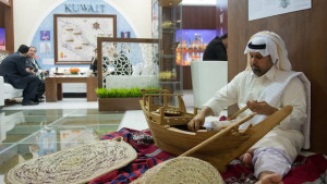 A man builds a traditional wooden ship at Kuwait's booth during the International Tourism Fair (ITB) in Berlin, Germany, on March 6, 2014. (EPA/INGA KJER)
