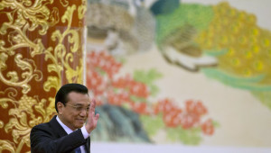 Chinese Premier Li Keqiang waves as he arrives for a press conference after the closing ceremony of the National People's Congress held in Beijing's Great Hall of the People, China, Thursday, March 13, 2014. (AP Photo/Ng Han Guan)