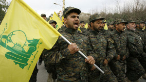 In this picture taken on Friday, February 14, 2014, Hezbollah fighters march in a parade during the memorial of their slain leader Sheik Abbas al-Mousawi, who was killed by an Israeli airstrike in 1992, in Tefahta village, south Lebanon. (AP Photo/Mohammed Zaatari)