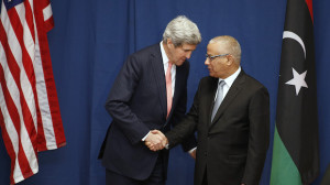 US Secretary of State John Kerry shakes hands with Libyan Prime Minister Ali Zeidan at the Conference on International Support to Libya, on March 6, 2014, in Rome. (AP Photo/Kevin Lamarque, Pool)