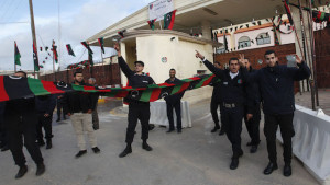 Police officers celebrate in front of a prison where Saadi Gaddafi, son of Muammar Gaddafi, is held, in Tripoli March 6, 2014. Niger has extradited Saadi, who just arrived in Tripoli and was brought to a prison, the Libyan government said on Thursday. The North African country had been seeking the extradition of Saadi, who had fled to the southern neighbour nation after the toppling of Gaddafi in a NATO-backed uprising in 2011. (REUTERS/Ismail Zitouny)