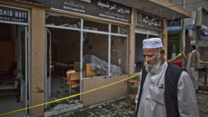 An elderly Pakistani man stands at the site of a twin suicide bombing in a court complex in Islamabad, Pakistan, on Tuesday, March 4, 2014. (AP Photo/Muhammed Muheisen)