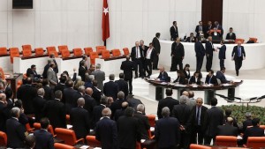Opposition members of the Turkish Parliament protest Deputy Chairman of the Parliament Sadik Yakut (rear, C) during a debate in Ankara March 19, 2014. Parliament convened in the capital Ankara for the hearing of a prosecutor report allegedly outlining the role of four former ministers in a corruption scandal that became public in December 2013. REUTERS/Umit Bektas