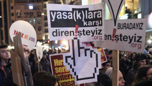 In this February 8, 2014, file photo, people hold a banner that reads " we resist against bans " as they protest against Internet restrictions in Istanbul, Turkey. Media reports say close to 80,000 people have stopped following Turkey's president Abdullah Gül on Twitter after he signed a controversial bill increasing government controls over the Internet into law on Wednesday, February 19, 2014. (AP Photo/Emrah Gurel, File)