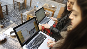 Two Turkish women try to get connected to the Twitter website with their laptops at a cafe in Istanbul, Turkey, on March 21, 2014.(EPA/TOLGA BOZOGLU)