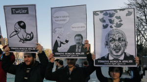 Members of the Turkish Youth Union hold cartoons depicting Turkey's Prime Minister Recep Tayyip Erdogan during a protest against a ban on Twitter in Ankara, Turkey, on Friday, March 21, 2014. (AP Photo/Burhan Ozbilici)
