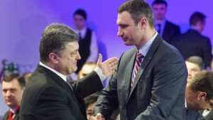 Ukrainian politicans Vitaly Klitschko (R) and Petro Poroshenko shake hands during an UDAR (Punch) party meeting in Kiev on March 29, 2014. (REUTERS/Andriy Skakodub/Pool )