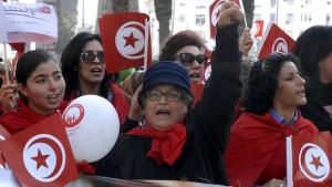 Tunisian women hold national flags as they take part in a march marking International Women's Day on March 8, 2014, in the capital, Tunis. (AFP PHOTO/FETHI BELAID)