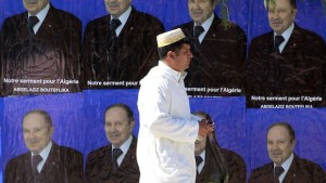 A man walks past electoral posters of the current Algerian president and candidate in the forthcoming presidential election, Abdelaziz Bouteflika, in Ain Ouassara, southwest of Algiers, on April 10, 2014. (REUTERS/Louafi Larbi)